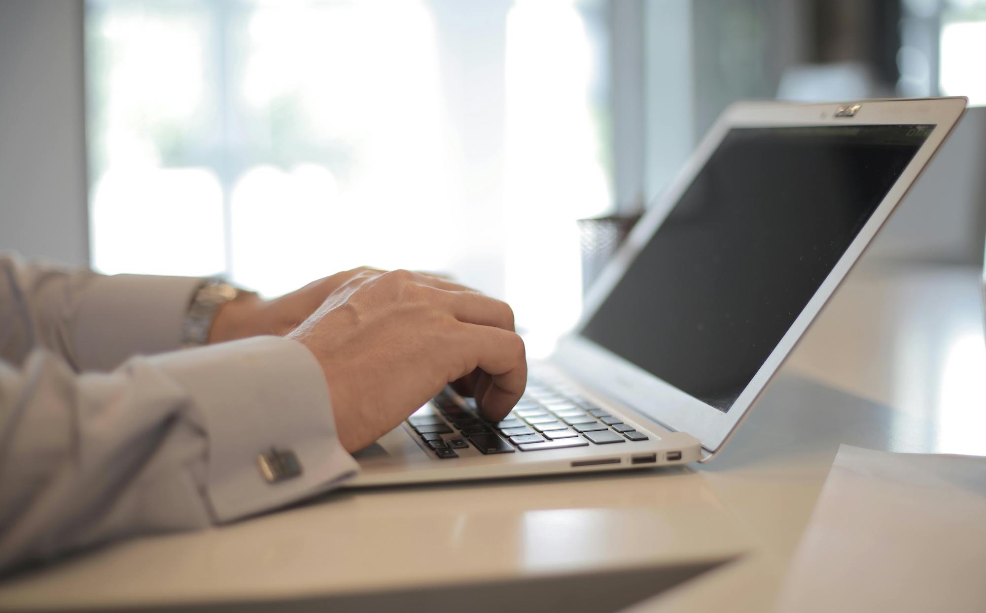 person typing on laptop